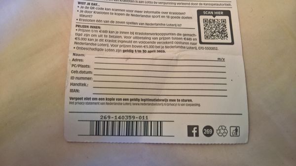 Back of a scratch lottery ticket with printed claim fields for name, address and signature and a barcode