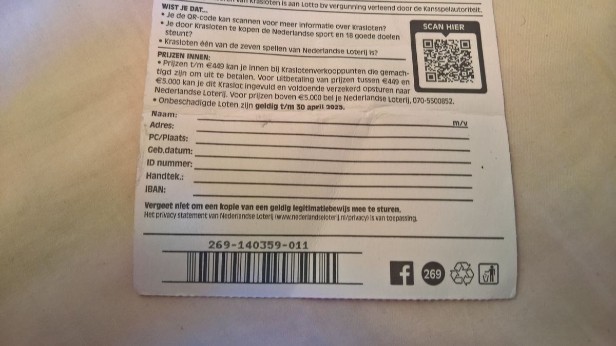 Back of a scratch lottery ticket with printed claim fields for name, address and signature and a barcode